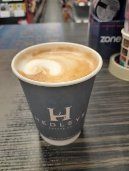 A latte with latte art in a Hedleys cup