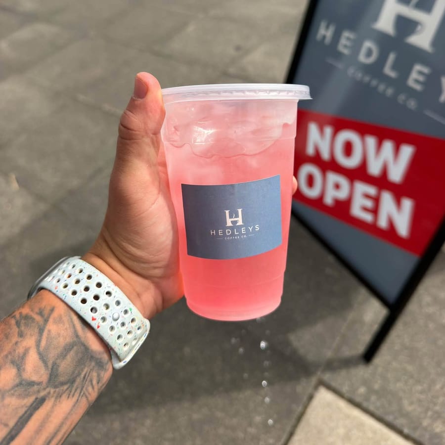 A strawberry lemonade over ice in a Hedleys cup